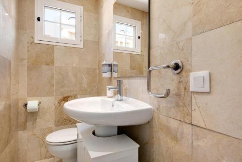 a bathroom with a sink and a toilet at Sol y Mar Caleta de Fuste in Caleta De Fuste