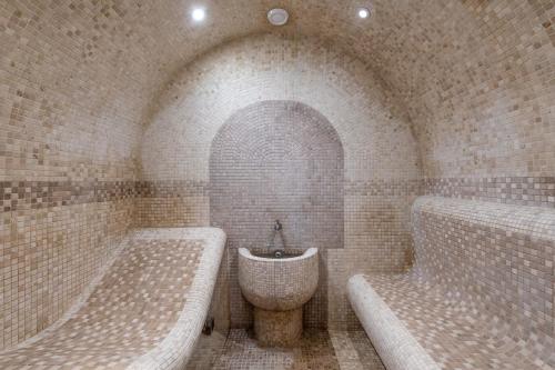 a bathroom with two tubs and a sink at Grand Hotel Pomorie - Medical spa in Pomorie