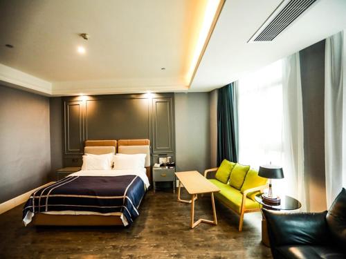 a hotel room with a bed and a couch at LanOu Hotel Suzhou Yongqiao Yingbin Avenue in Suzhou