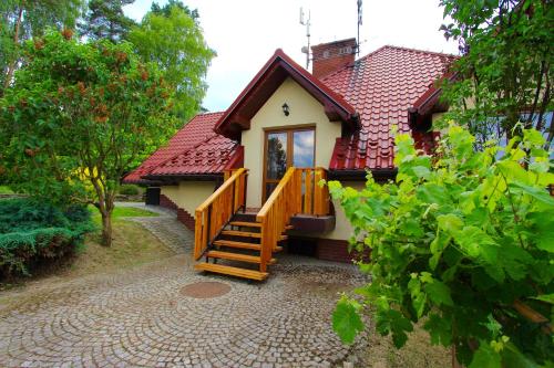 a small house with a staircase leading to it at KOŃSKA GÓRKA Agroturystyka in Rabka