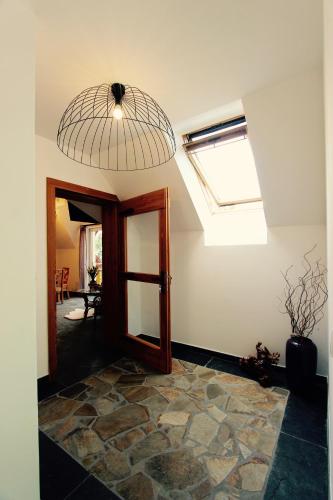 a room with a skylight and a door and a window at KOŃSKA GÓRKA Agroturystyka in Rabka