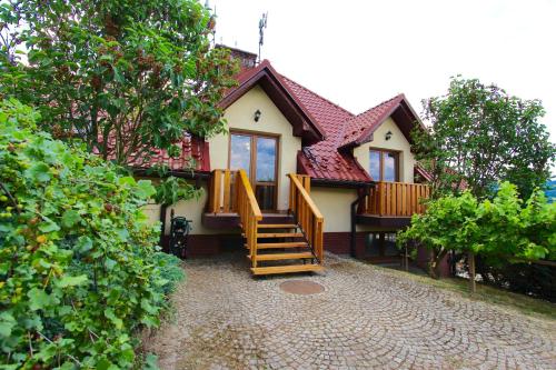 a house with a staircase in front of it at KOŃSKA GÓRKA Agroturystyka in Rabka