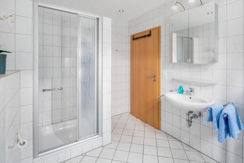a bathroom with a shower and a sink at La Lézardière in Norderney