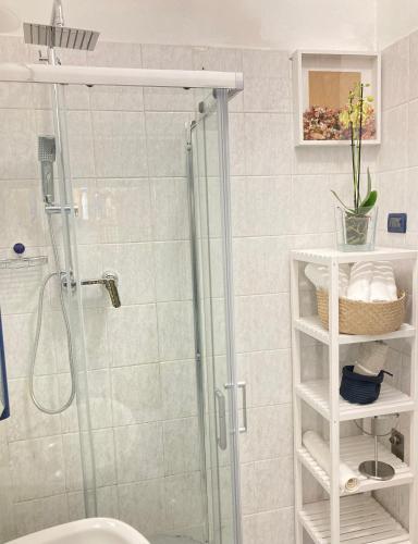 a bathroom with a shower and a toilet and a sink at Casa Luna - Airport in Pisa