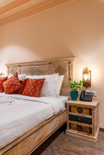 a bedroom with a large bed and a telephone at Anand Bagh Resort & Spa by Ananta in Sālāsar