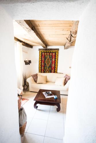 a living room with a couch and a table at Freelandros Villa in Nardodipace