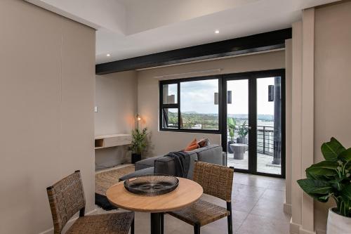 a living room with a table and chairs at BlackBrick Sandton Two in Johannesburg