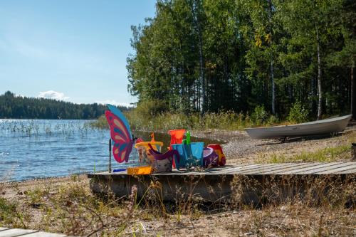 a colorful kite sitting on a dock next to a lake at Saimaan Kultaranta in Puumala