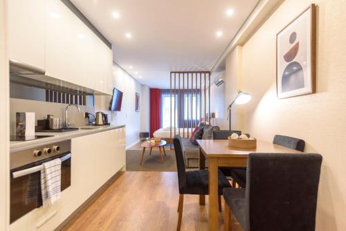 a kitchen and dining room with a table and a dining room at Braga Center Apartments - São Vicente in Braga