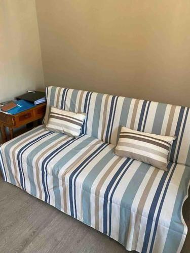 a couch in a room with two pillows on it at Nenè al mare appartamento con posto auto wifi e idromassaggio in Santa Margherita Ligure