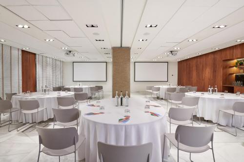 a conference room with white tables and chairs at The Level at Melia White House in London