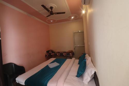 a bedroom with a bed with a ceiling fan at Triple One Hotel Tapovan Rishikesh,Near Laxman Jhula in Rishīkesh