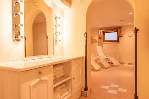 a bathroom with a sink and a mirror at Hotel Garni Apart TINA in Ischgl