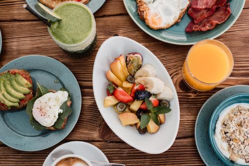 a table topped with plates of food and drinks at Can Vistabella Boutique Resort in San Antonio