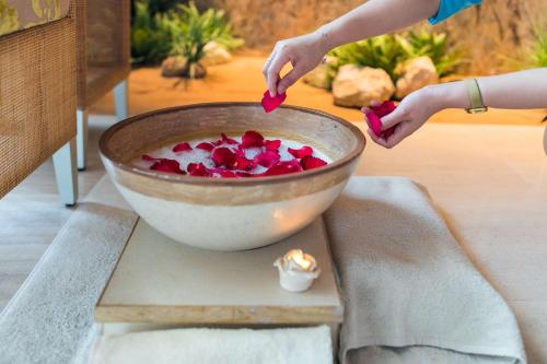 a person holding a heart in a bowl of food at Andaz Capital Gate Abu Dhabi, By Hyatt in Abu Dhabi
