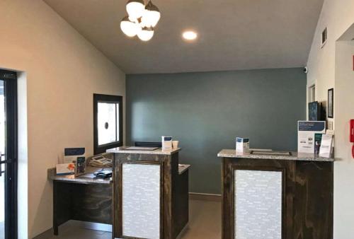an office with two desks and a green wall at Rodeway Inn South in Calhoun
