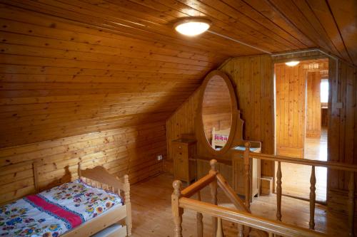 a bedroom in a log cabin with a bed in it at Chalúpka Rozprávkovo in Šumiac