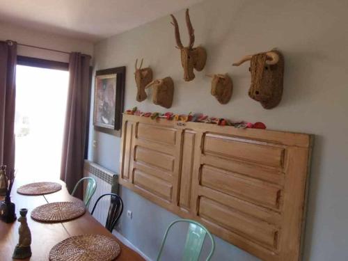 a dining room with a table and a wooden cabinet at Casa Iona chalet adosado con vistas a la montaña in Navarredonda de Gredos