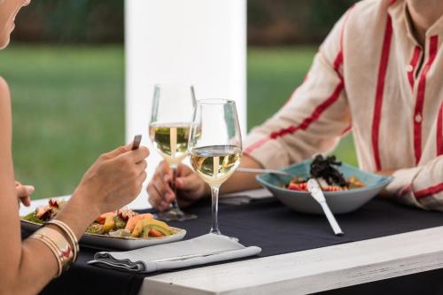 un gruppo di persone seduti a un tavolo con bicchieri da vino di Petit Sagitario Adults only a Ciutadella