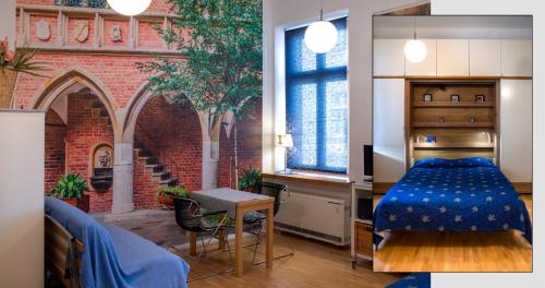 a bedroom with a bed and a brick wall at New Sweet One in Krakow