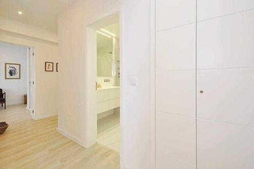 a white bathroom with a shower and a tub at Prestige Sunset Carcavelos Beach - Checkinhome in Carcavelos