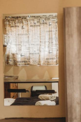 a room with a bed and a curtain with writing on it at Casa Leitao Lodge in Phalaborwa