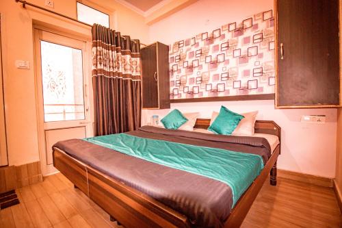 a bedroom with a large bed in a room at Triple One Hostel Tapovan Rishikesh in Rishīkesh