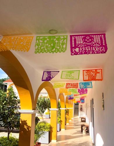 a hallway of a building with colorful flags on the ceiling at Casa Blanca Hotel in Jalpan