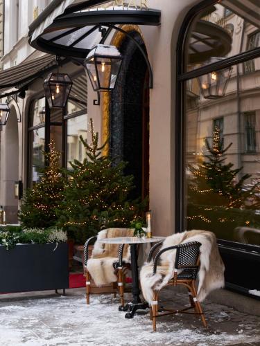 a table and chairs in front of a store with christmas trees at Villa Dagmar in Stockholm
