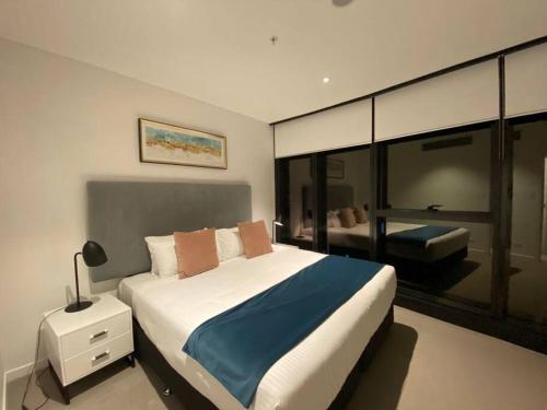 a bedroom with a large bed and a large window at New! Great Value - Skytower center of CBD in Brisbane