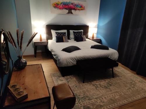 a bedroom with a large bed with pillows on it at Gîte La Renéade in Foyr
