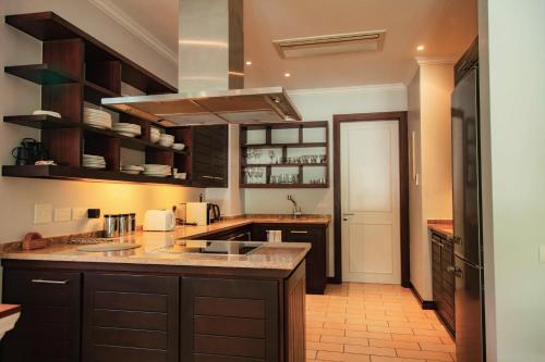 a kitchen with a sink and a counter top at Maison La Plage by Simply-Seychelles in Eden Island