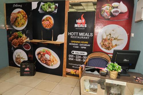 a restaurant with a menu of food on a wall at Legon City Mall Short Stay Apartments for Business and Vacation - East Legon in Accra