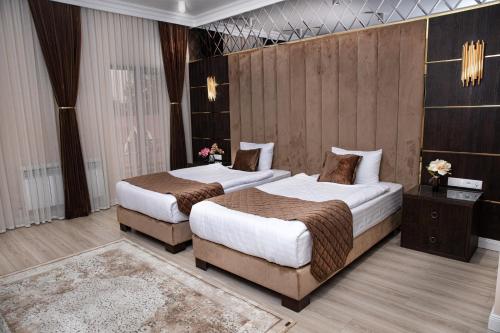 a hotel room with two beds in a room at Marokand Spa Hotel in Samarkand