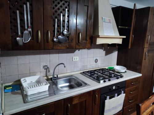 a kitchen with a sink and a stove at Casa Scanno centro storico in Scanno