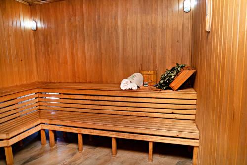 a wooden paneled sauna with a wooden bench in it at Marokand Spa Hotel in Samarkand