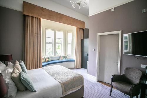 a bedroom with a large bed and a window at Hartsfield Manor in Dorking