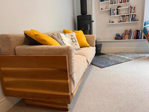 a living room with a couch and a fireplace at Halwell House - A Spacious Quiet Apartment in Kingsbridge