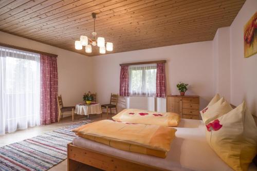 a bedroom with two beds and a table at Ferienhaus Lanzinger in Söll