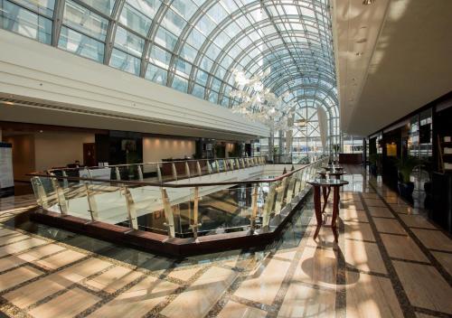 a large shopping mall with a glass ceiling at Dusit Thani Dubai in Dubai