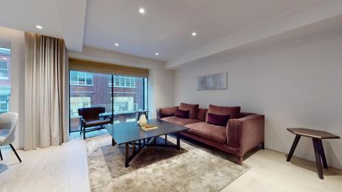 a living room with a couch and a table at Maddox Street in London