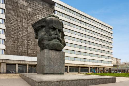 a bust of a man in front of a building at Super 8 by Wyndham Chemnitz in Chemnitz
