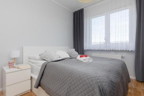a bedroom with a bed with two stuffed animals on it at Warsaw Young City Apartment by Renters in Warszawa