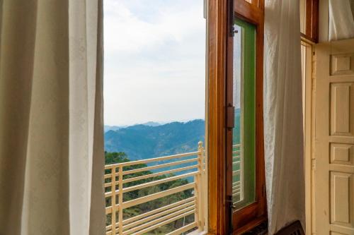 a window with a view of a mountain view at Jot Eco Boutique Stays in Dharamshala