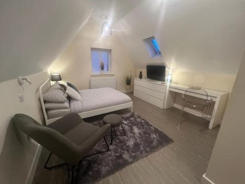 a bedroom with a bed and a chair and a desk at 8 Studio, cosy loft, 50m to Airbus, bus-stop 20m, in Bristol