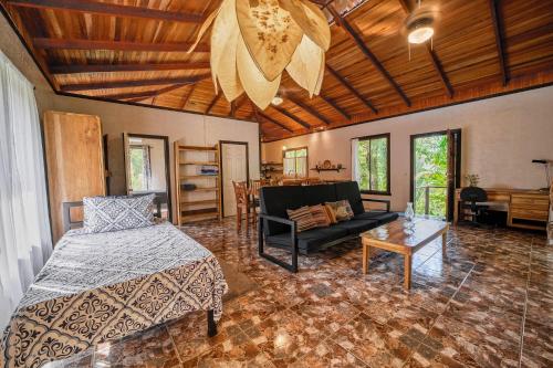 a living room with a bed and a couch at Azania Oasis in Puerto Viejo