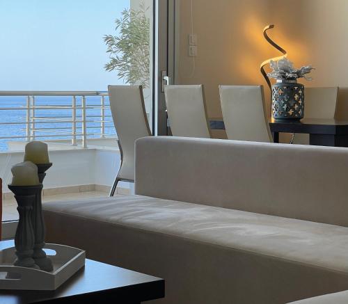 a living room with a couch and a table with chairs at Villa Proistakis in Achlia