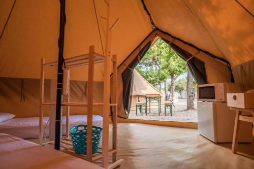 a tent with two bunk beds in a room at Camping Cambrils Caban in Cambrils