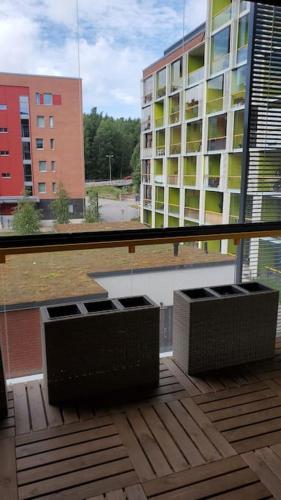 a balcony of a building with a view of a building at Studio, 9 min walk to train+15 min city or airport in Vantaa