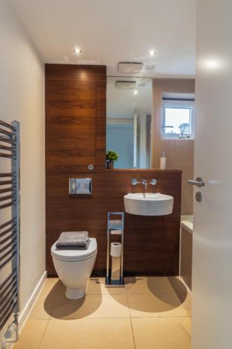 a bathroom with a toilet and a sink at The Penthouse Suite - Luxury Like No Other in Glasgow